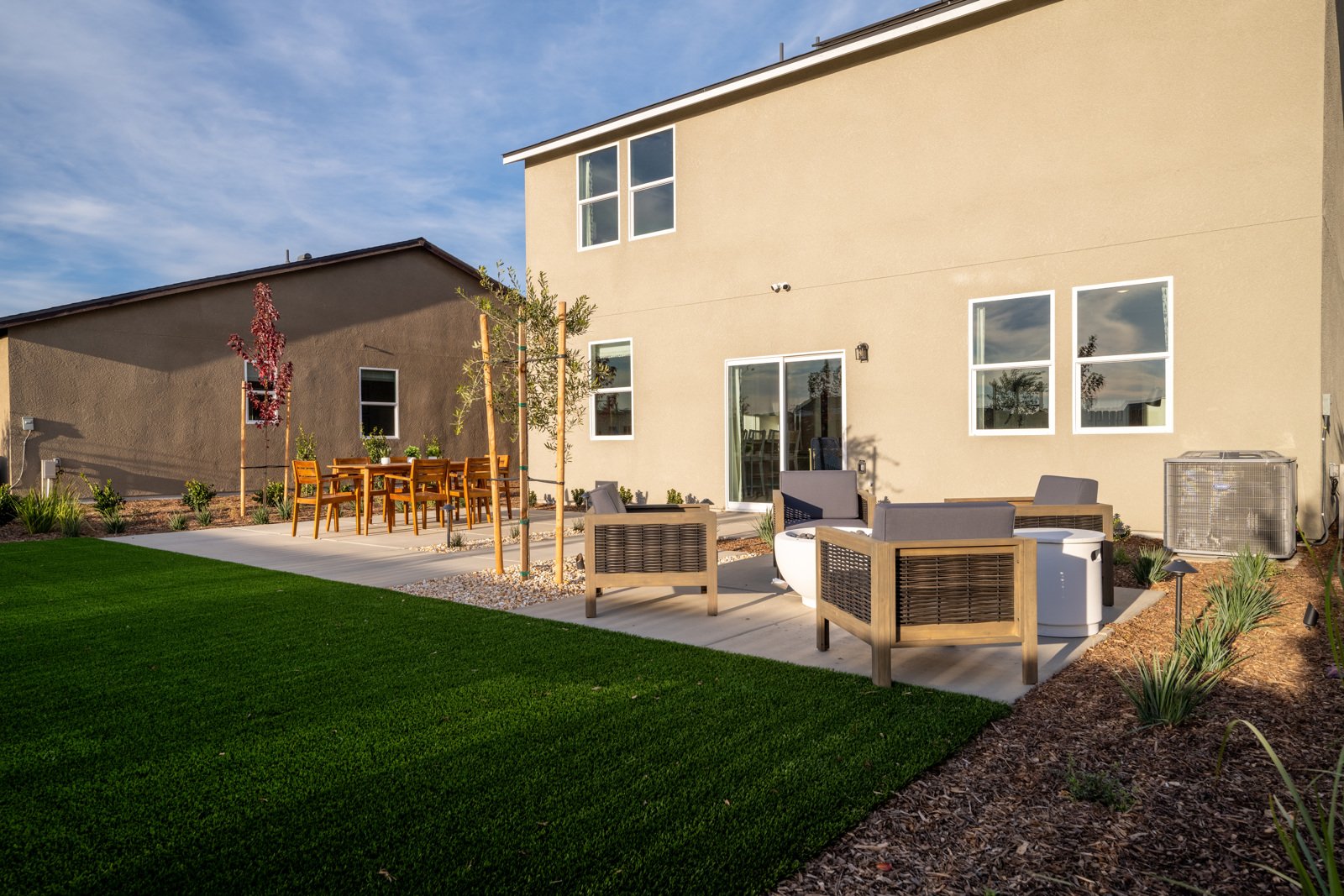 A backyard with a picnic table and chairs.