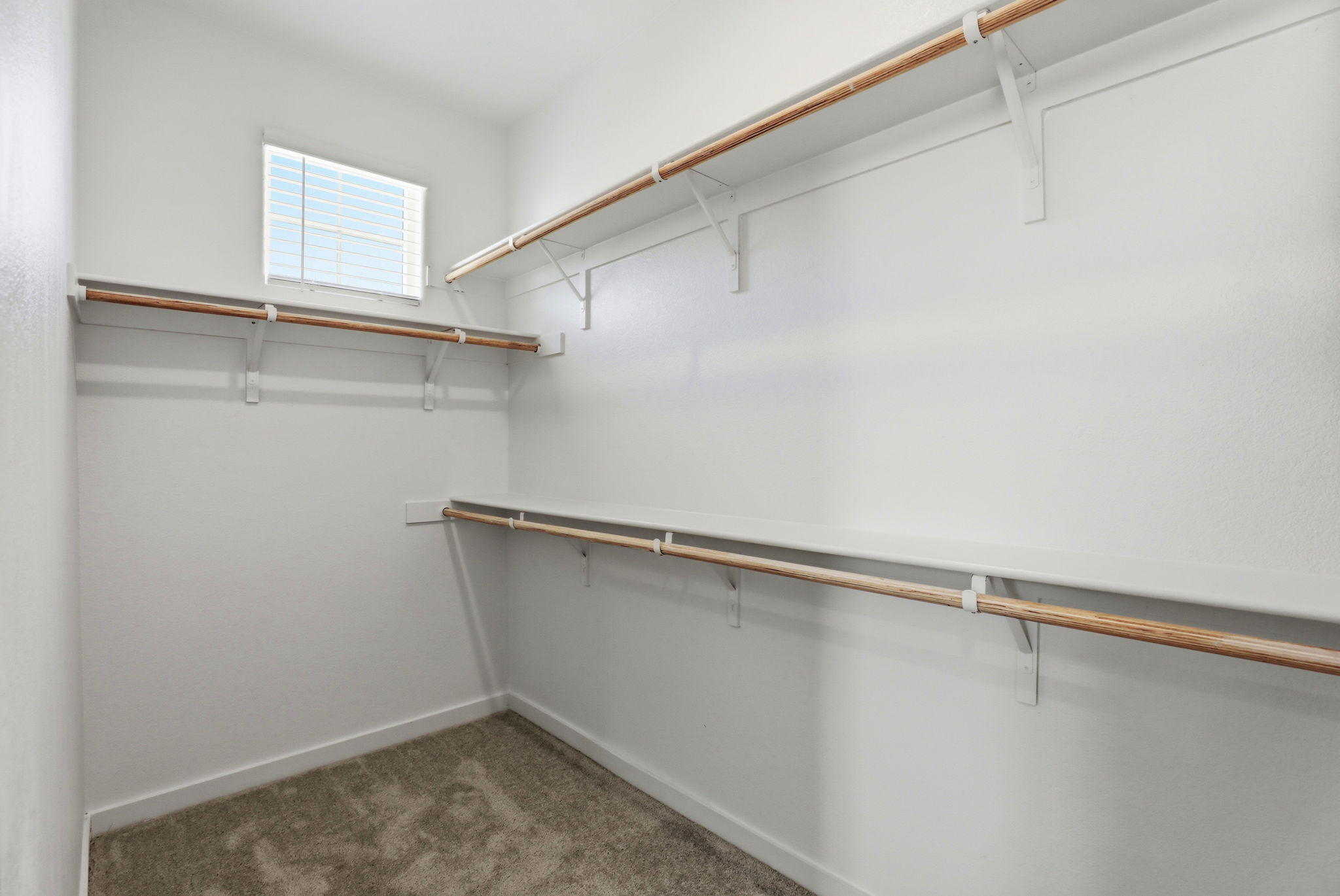 A white room with a metal railing.