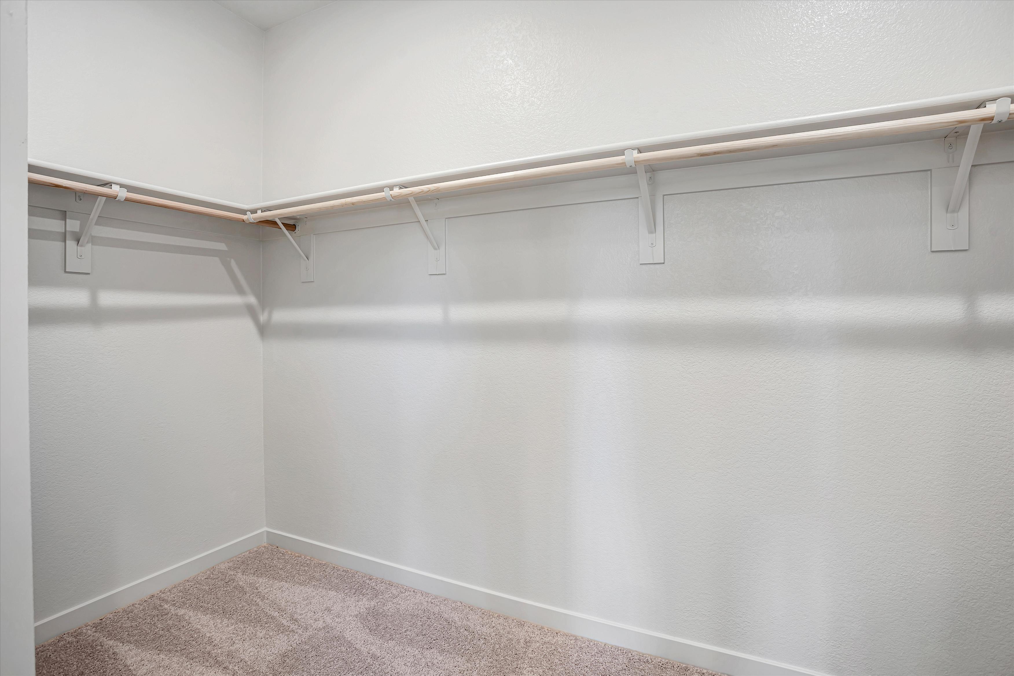 A white wall with a metal bar.