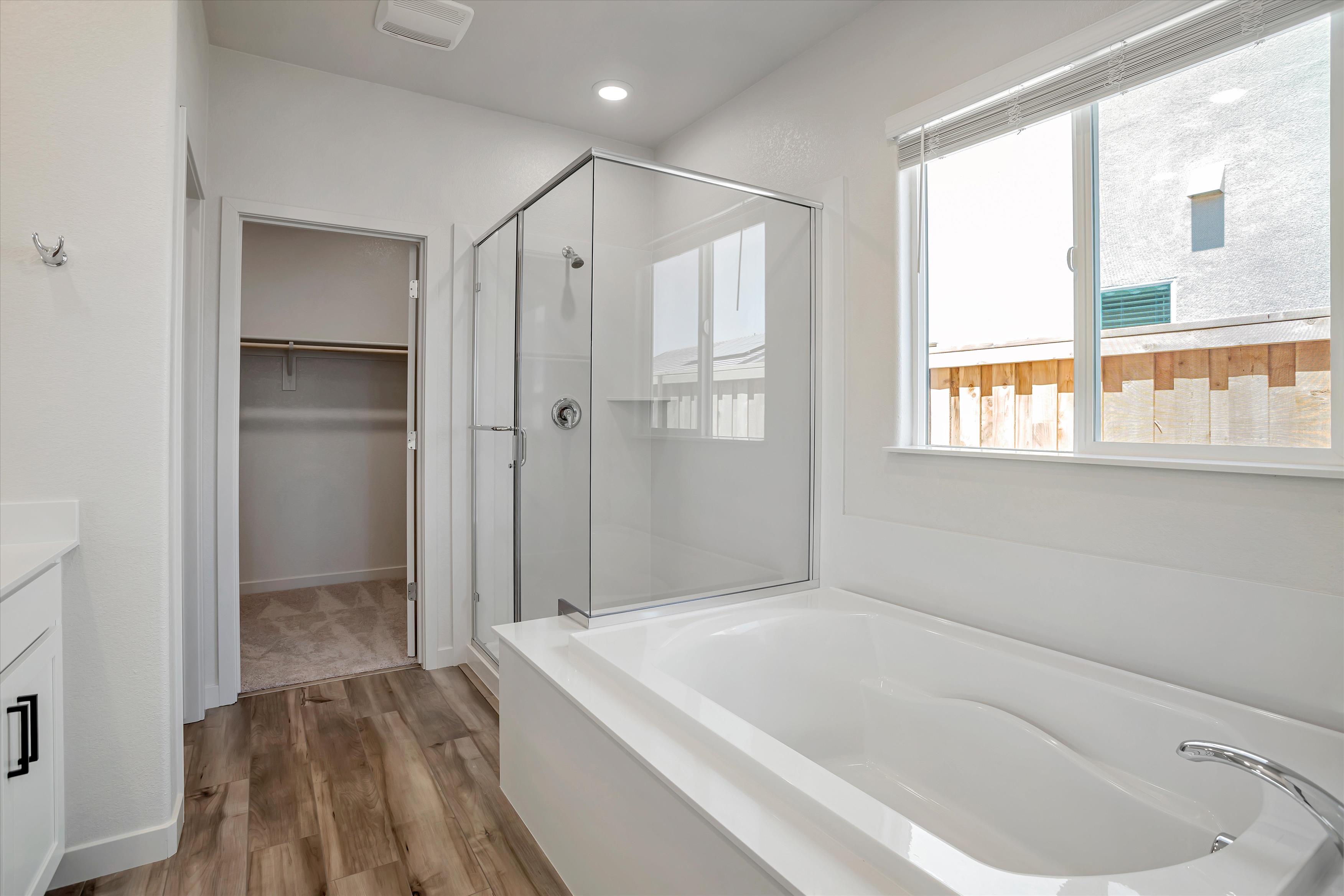 A bathroom with a tub and shower.
