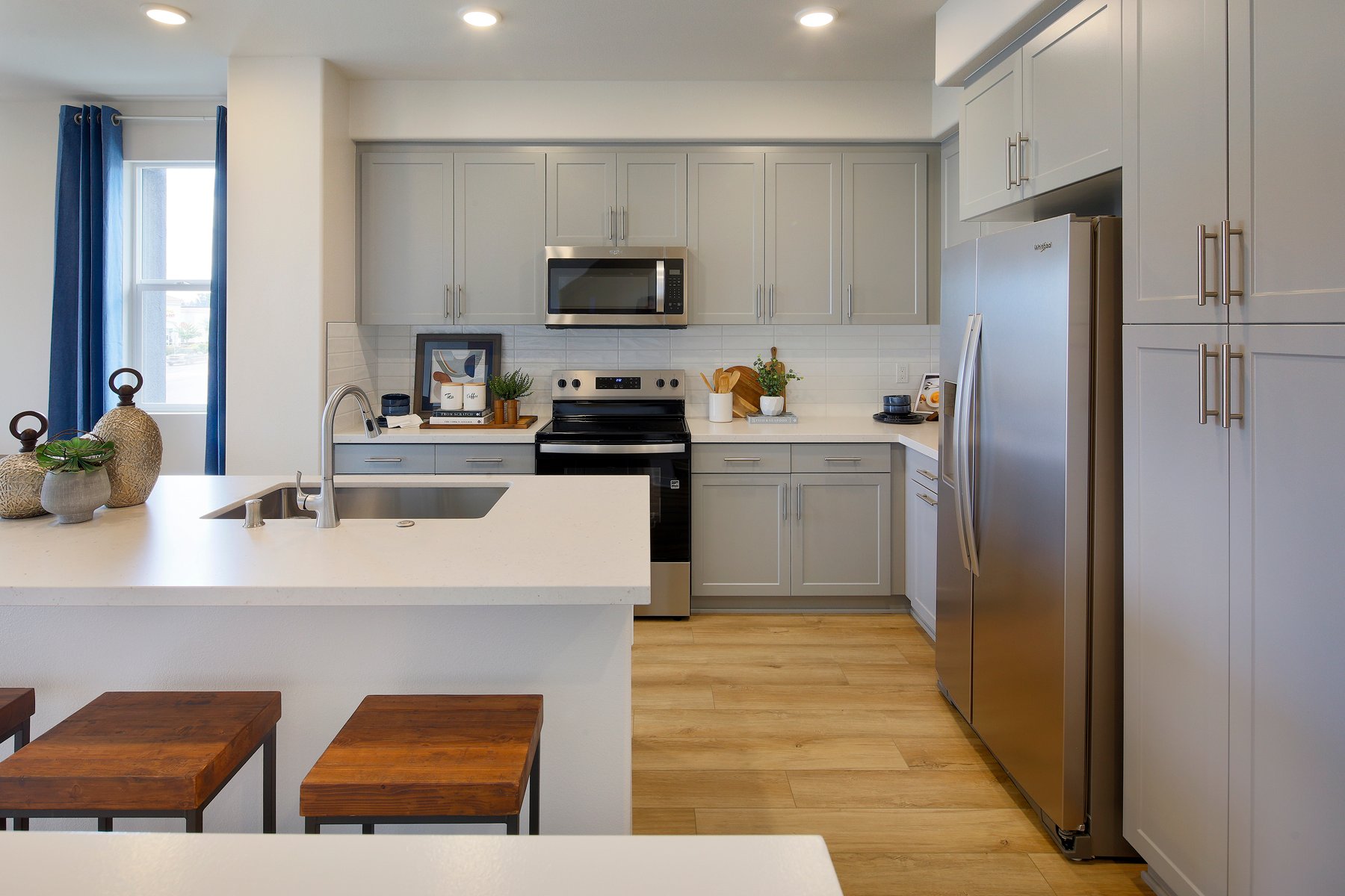 A kitchen with white cabinets.