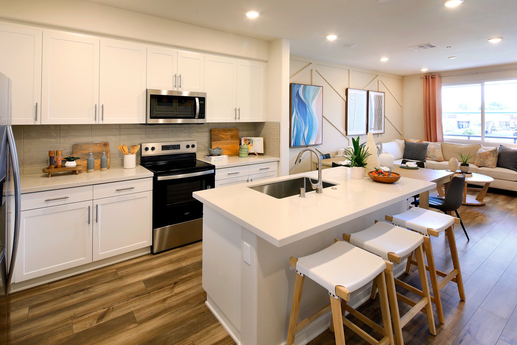 A kitchen with white cabinets.