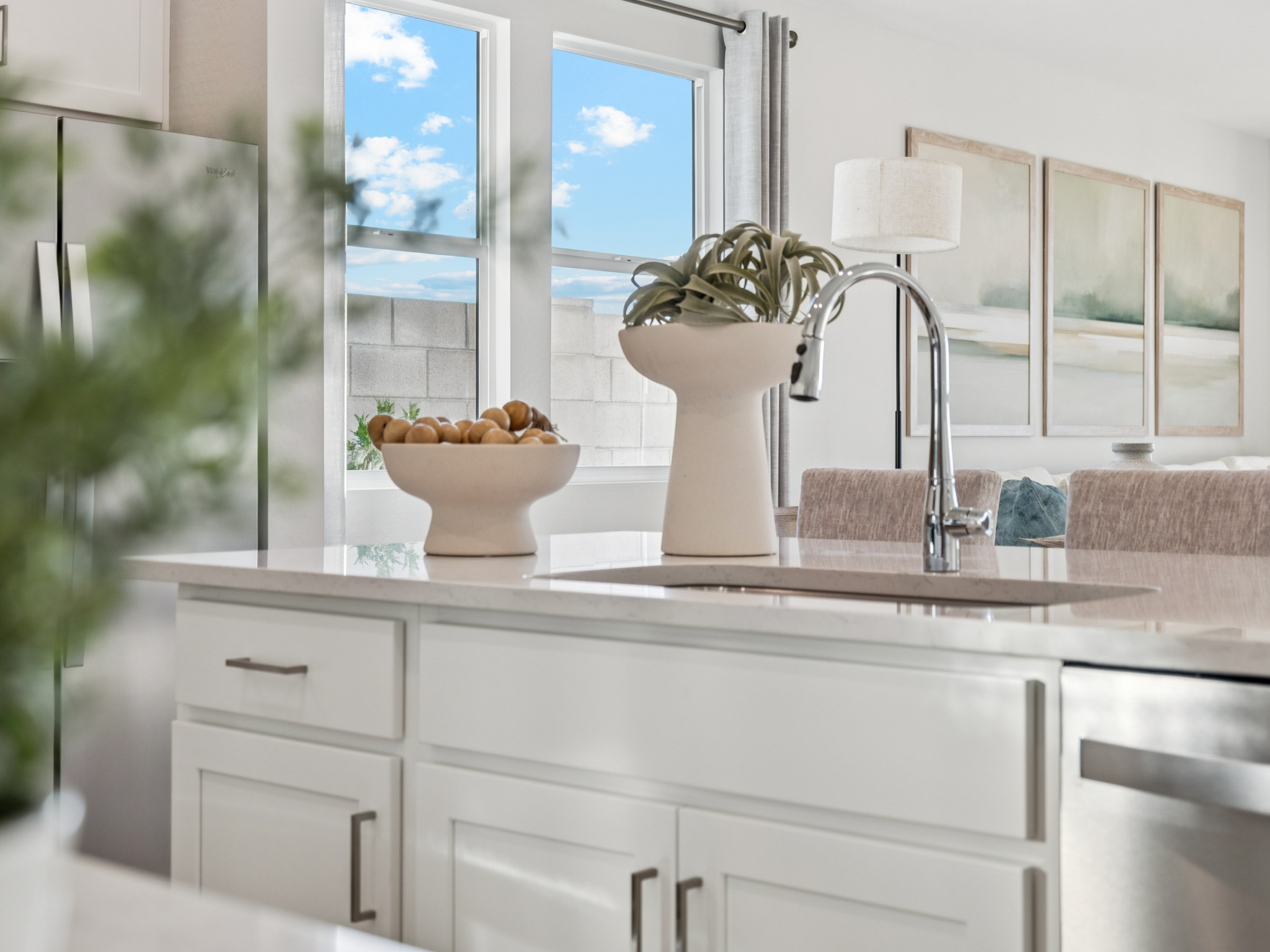 A kitchen with a sink and a plant.