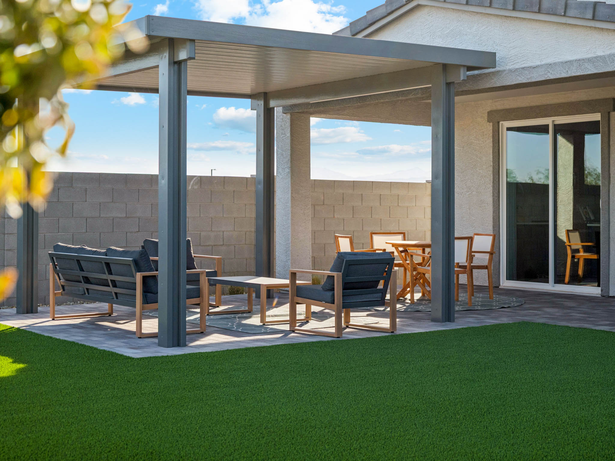 A patio with tables and chairs.
