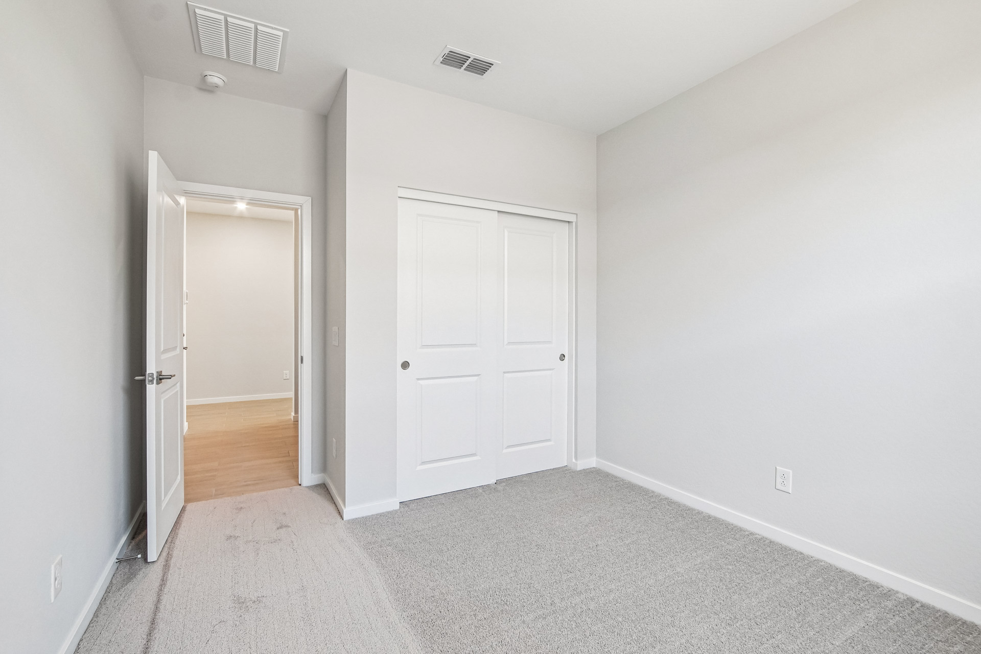 A hallway with white doors.