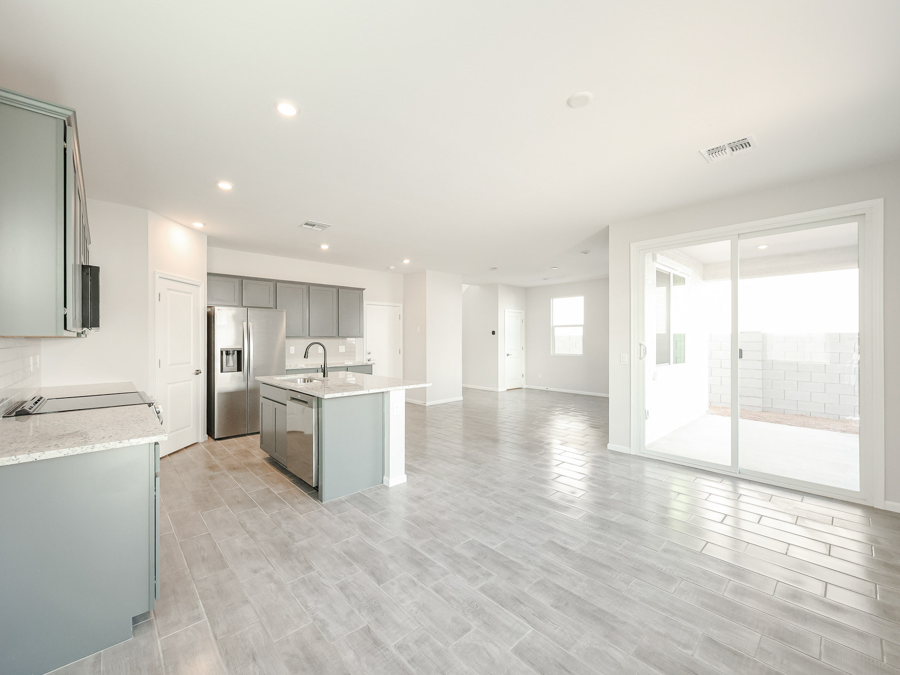 A large kitchen with a wood floor.