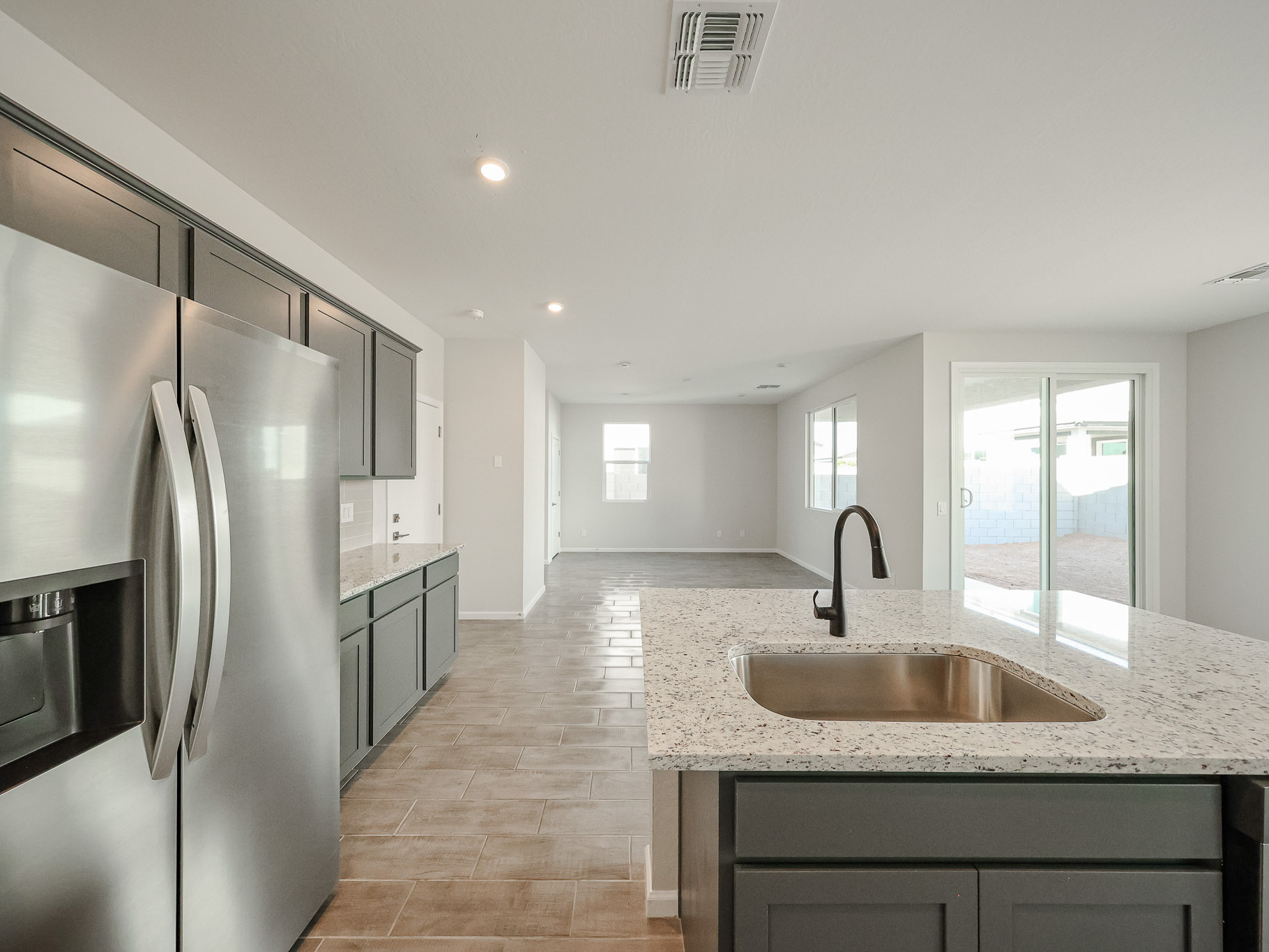 A kitchen with a marble counter top.