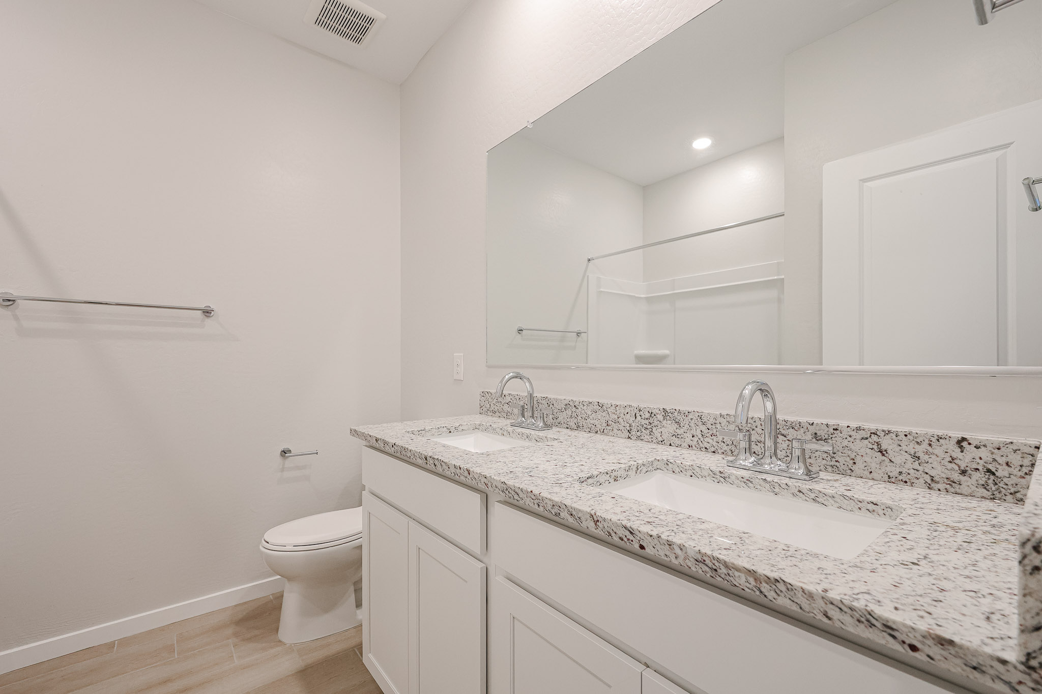 A bathroom with a marble countertop.