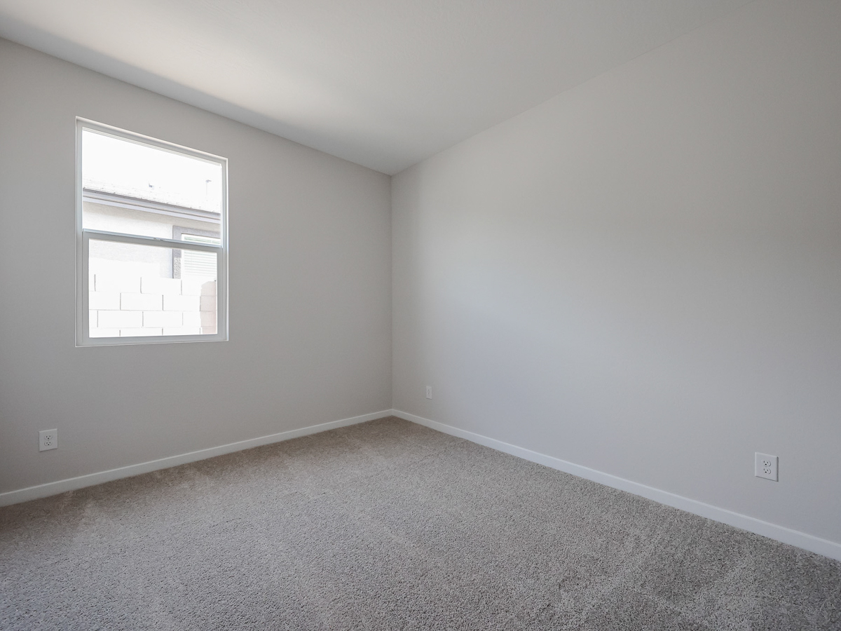 A room with a window and carpet.