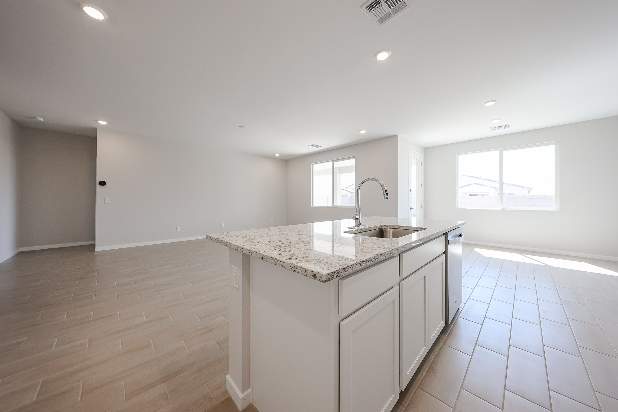 A kitchen with white cabinets.