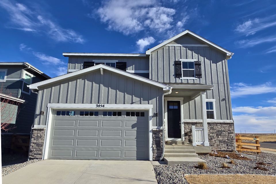 A white house with a garage.