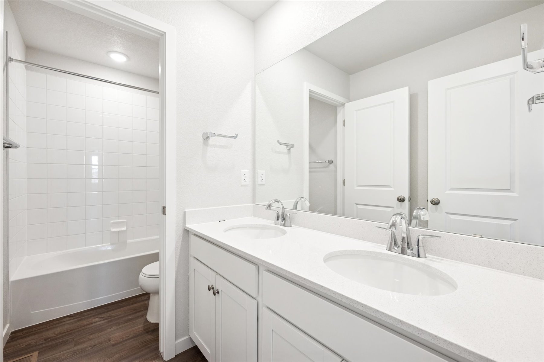 A bathroom with a tub sink and toilet.