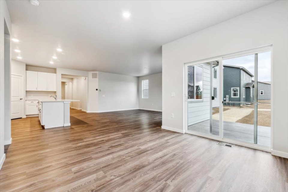 A large empty room with glass doors.
