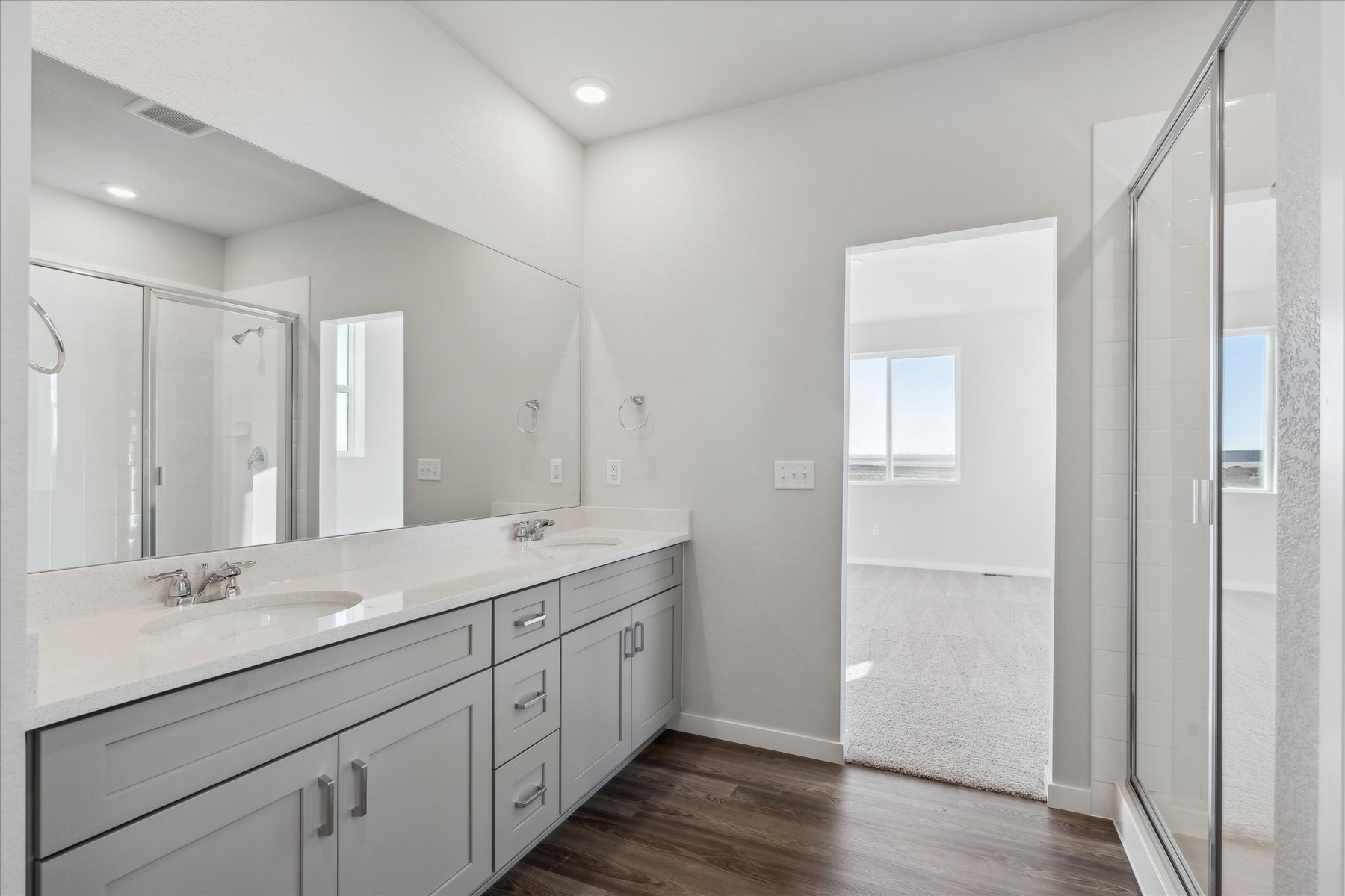 A bathroom with a large mirror.