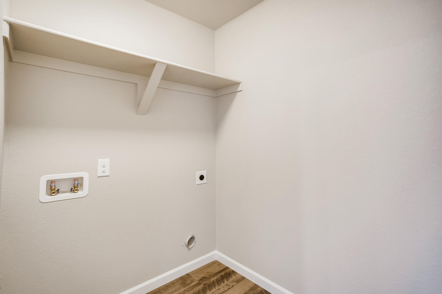 A white wall with a light fixture.