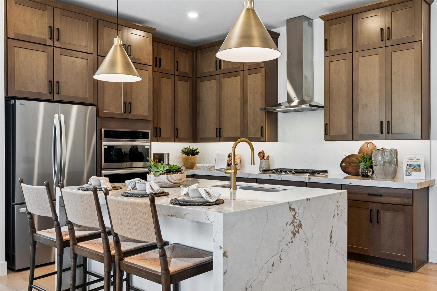 A kitchen with a table and chairs.