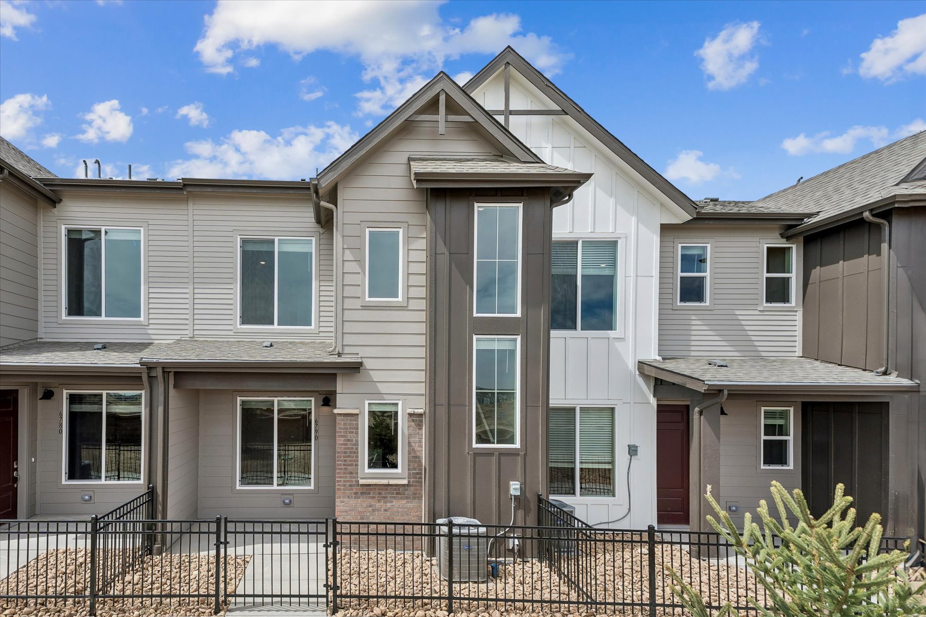 A large house with a fence in front of it.