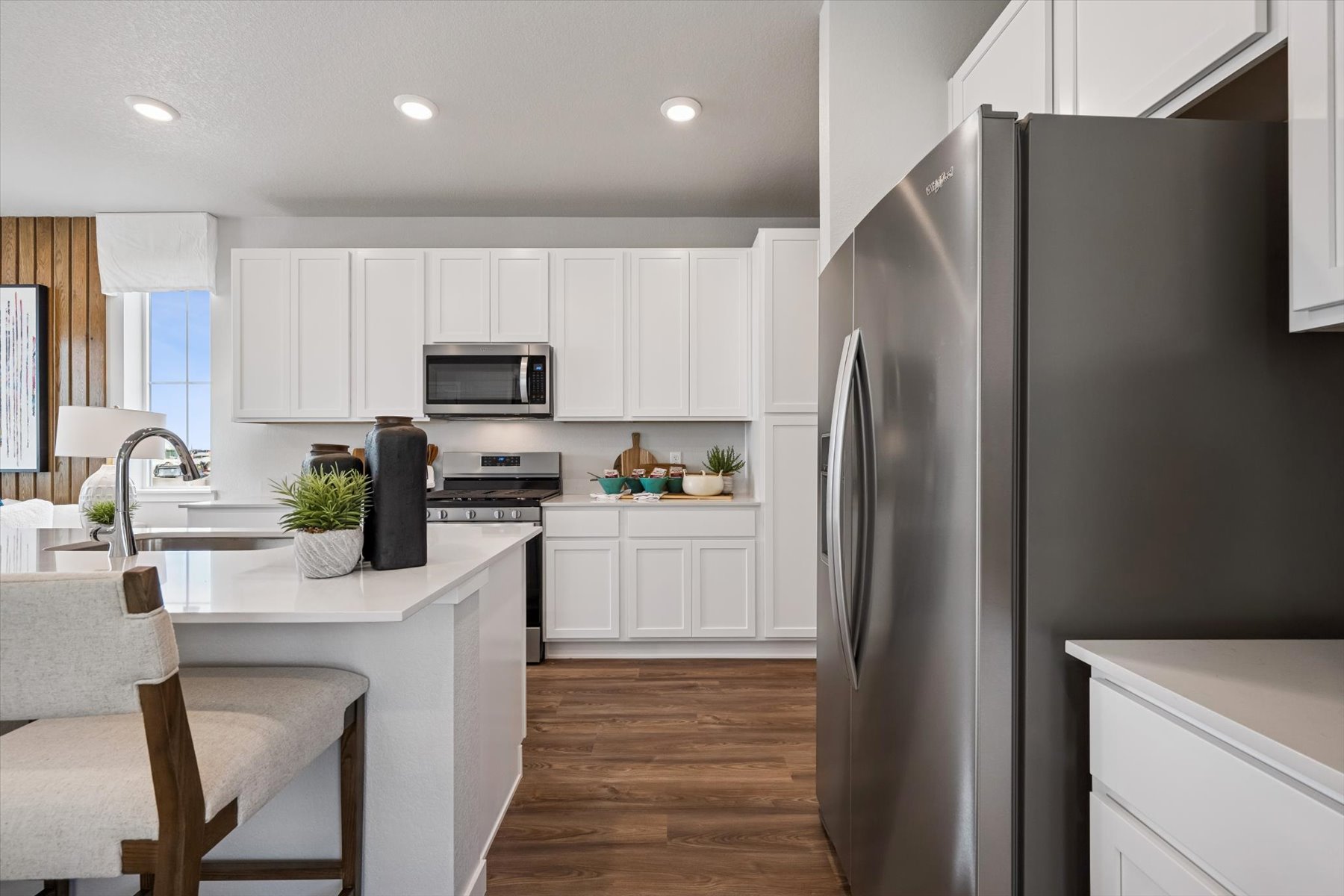 A kitchen with white cabinets.