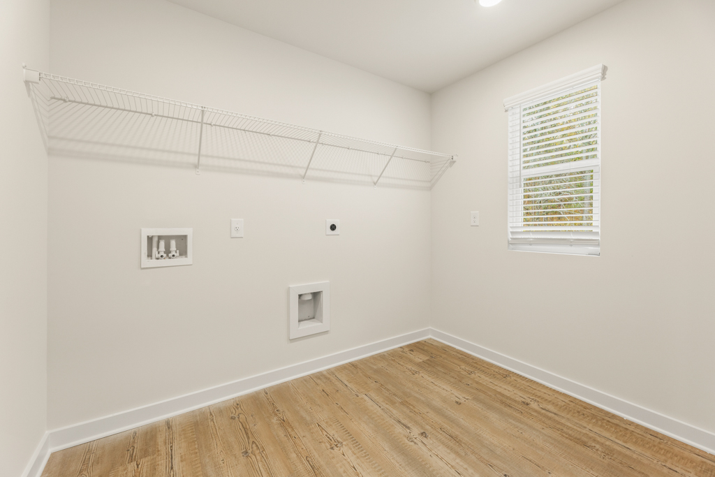 A room with a wood floor and white walls.