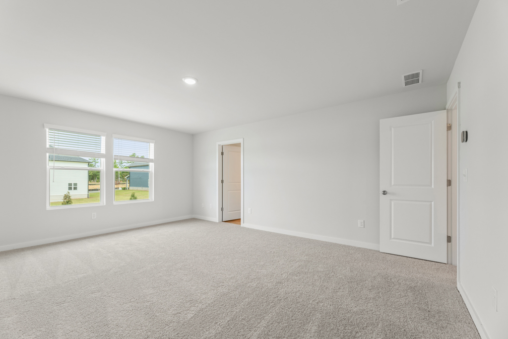 A room with white walls and a window.