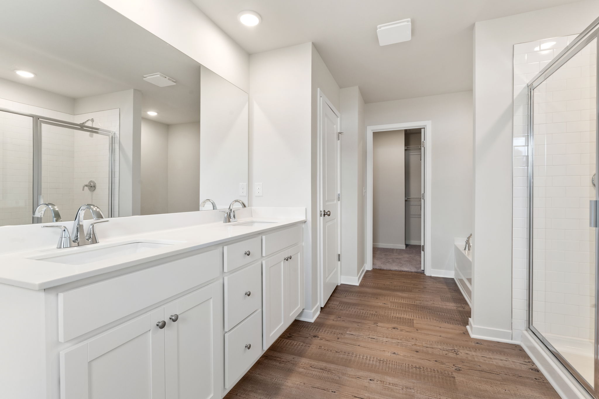 A bathroom with white cabinets.