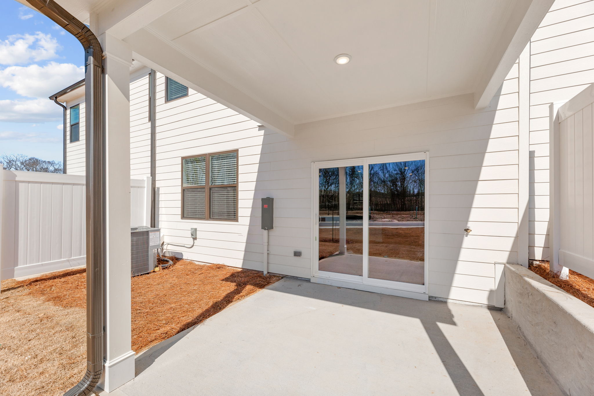 A white house with a large glass door.
