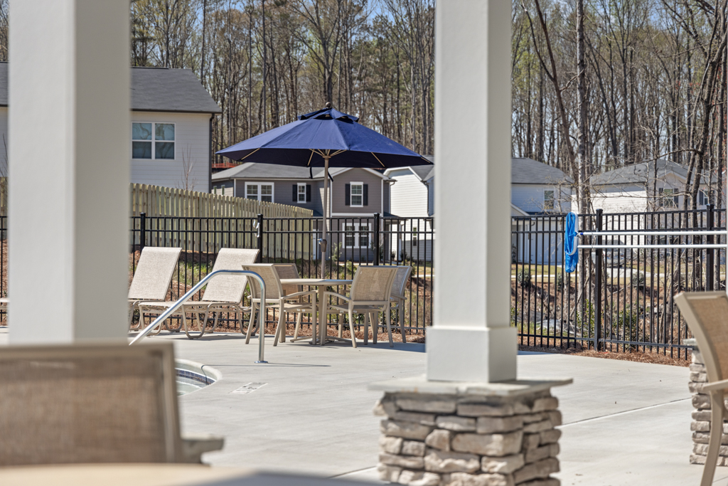 A patio with tables and chairs.
