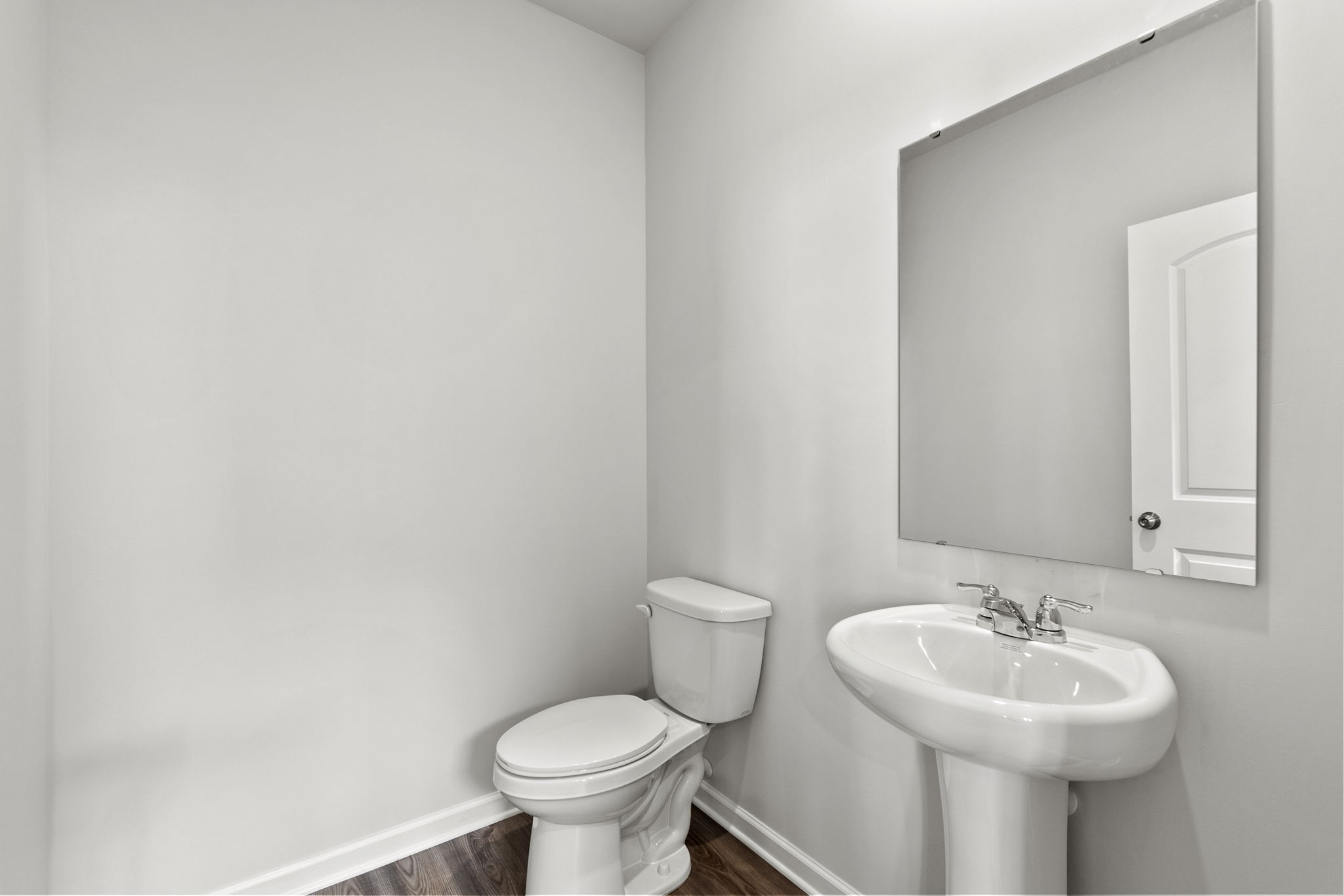 A bathroom with a toilet and sink.