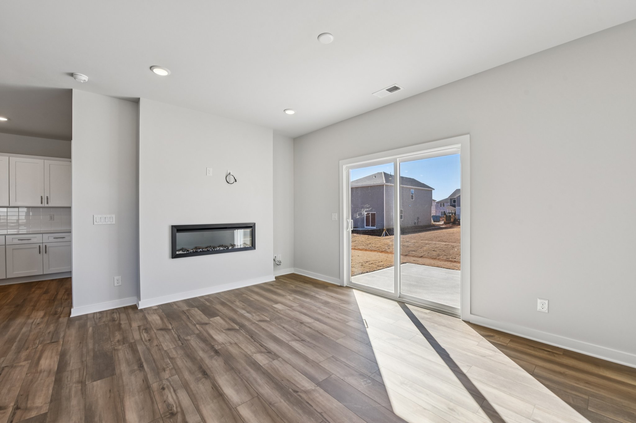 A room with a wood floor and white walls.