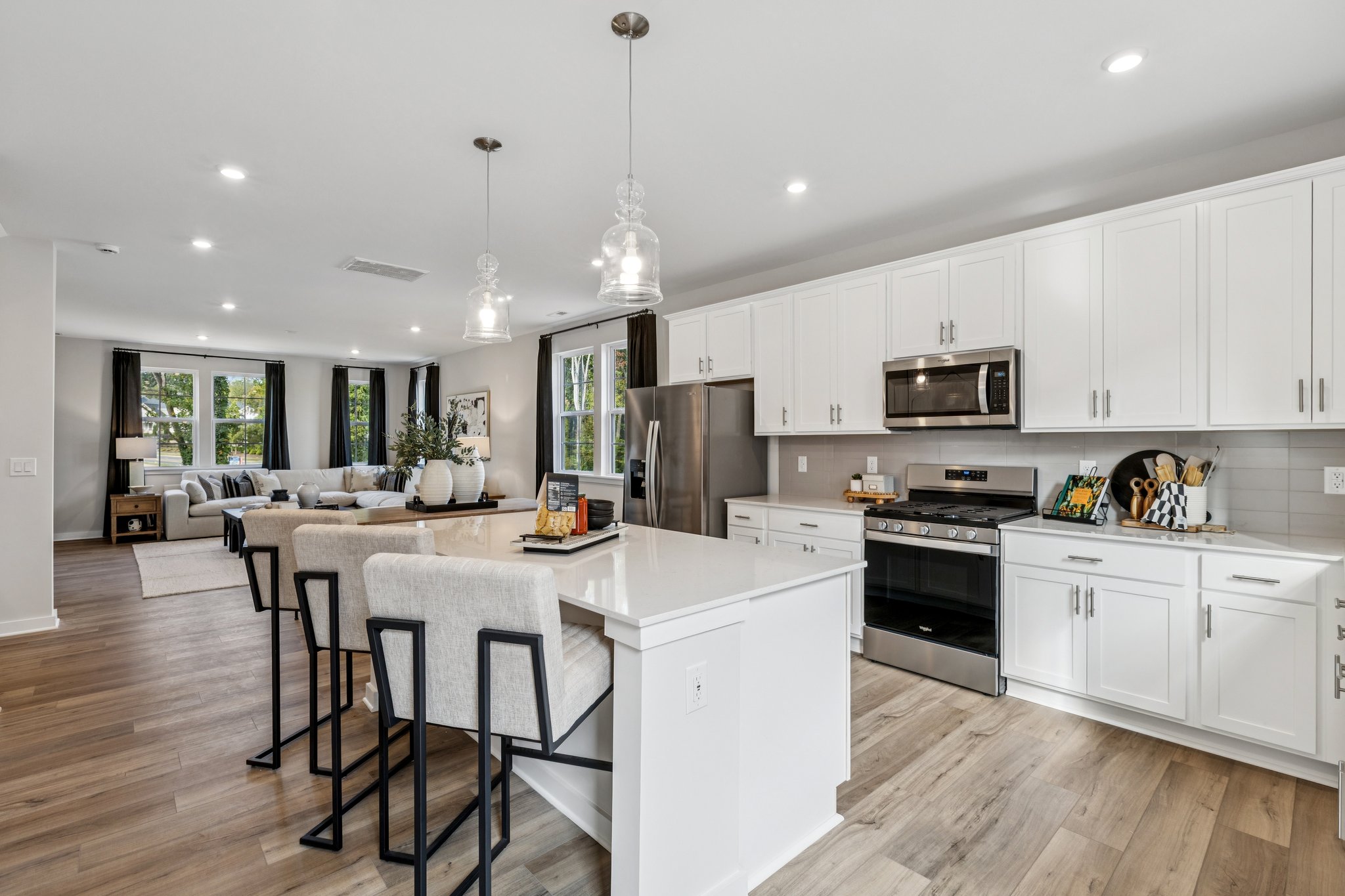 A kitchen with white cabinets.