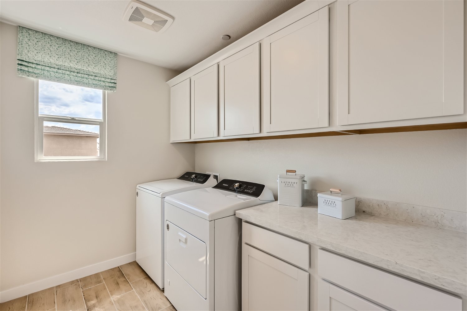 A kitchen with white cabinets.