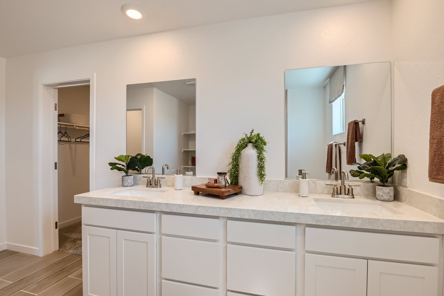 A bathroom with white cabinets.