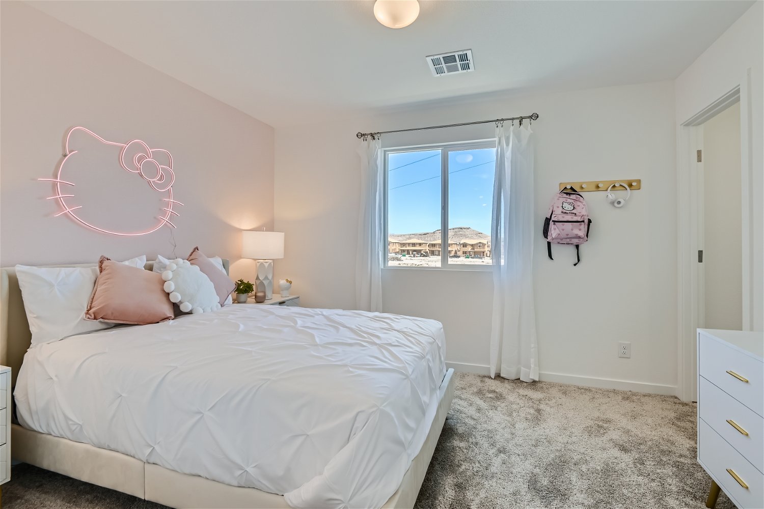 A bedroom with a bed and a window.