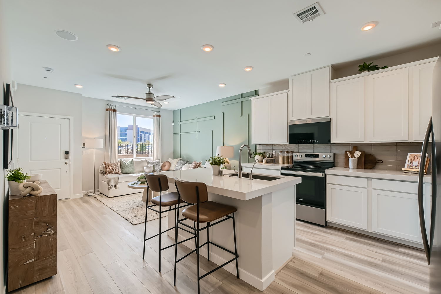 A kitchen with white cabinets.
