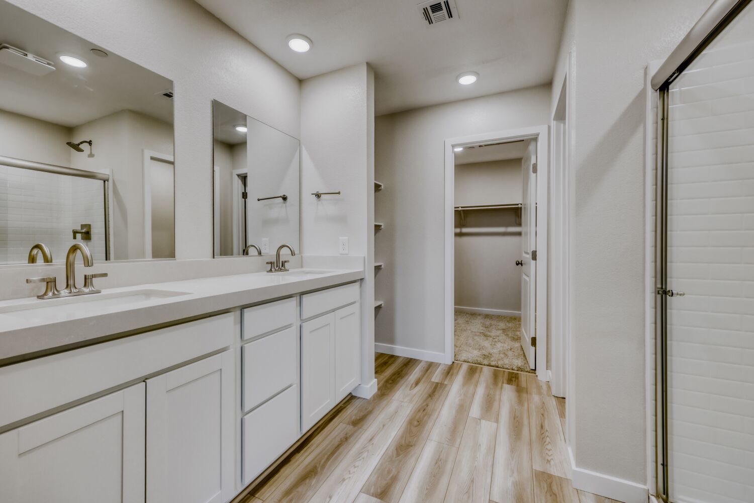 A bathroom with white cabinets.