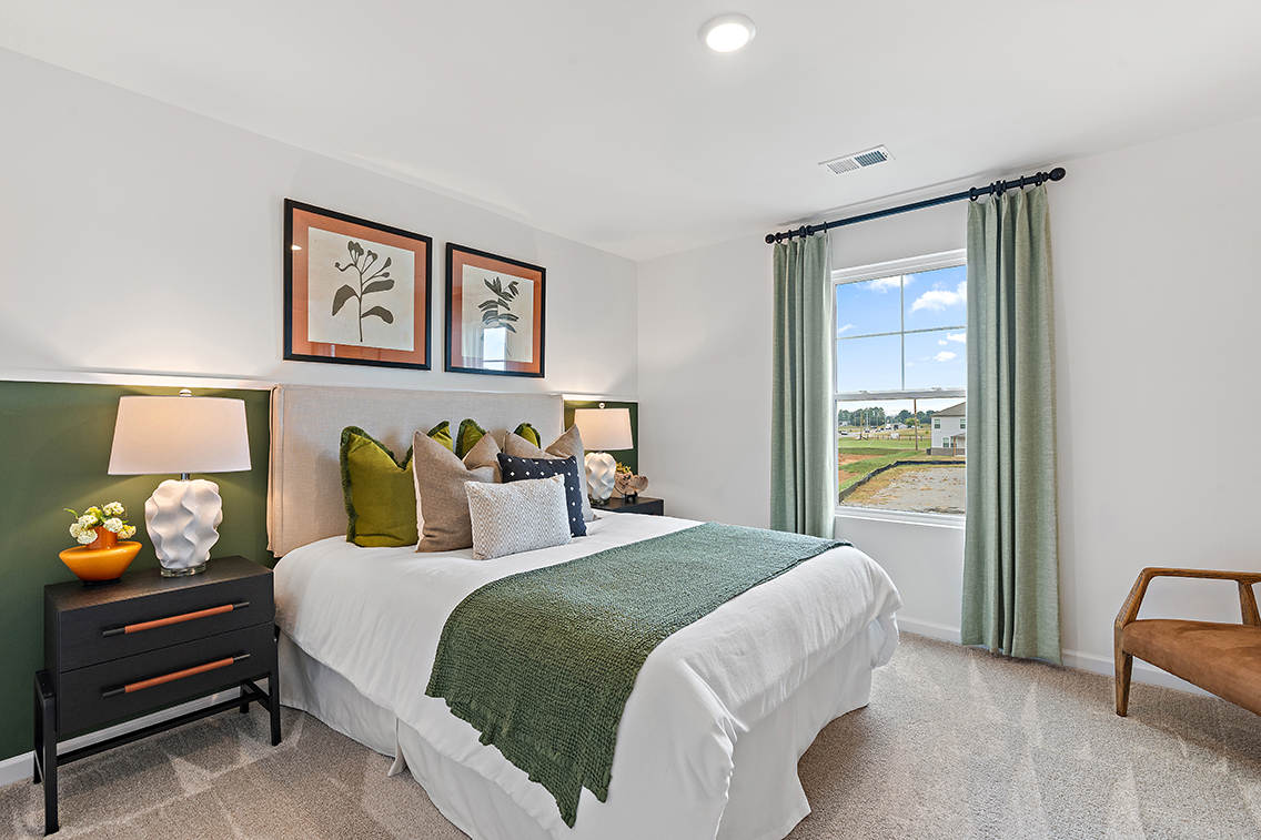 A bedroom with a large window.