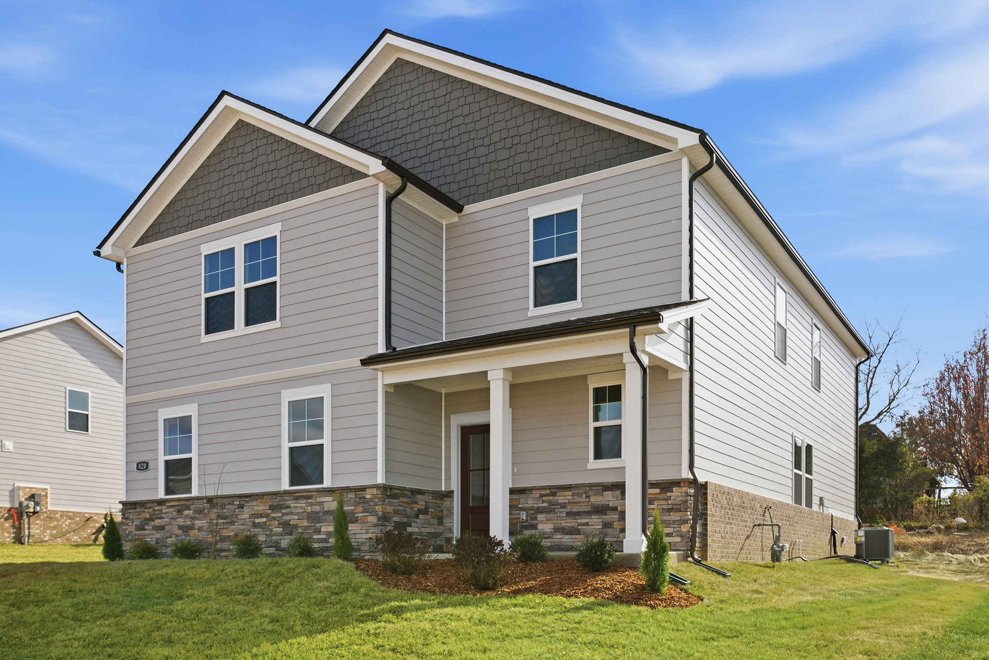 A house with a lawn in front.