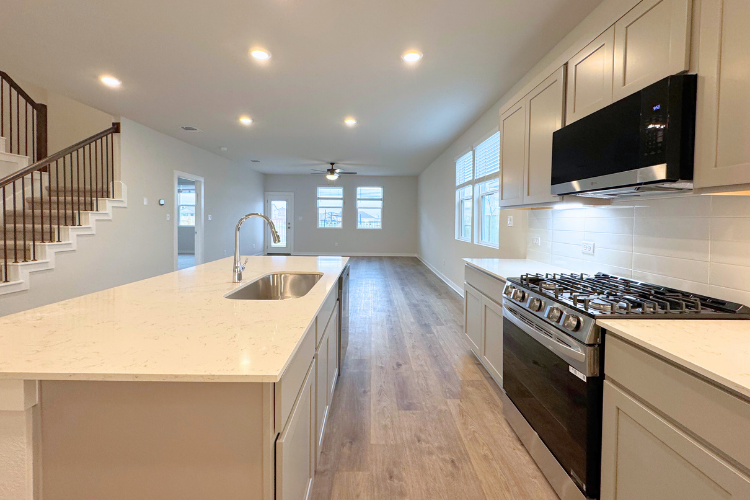 A kitchen with white cabinets.