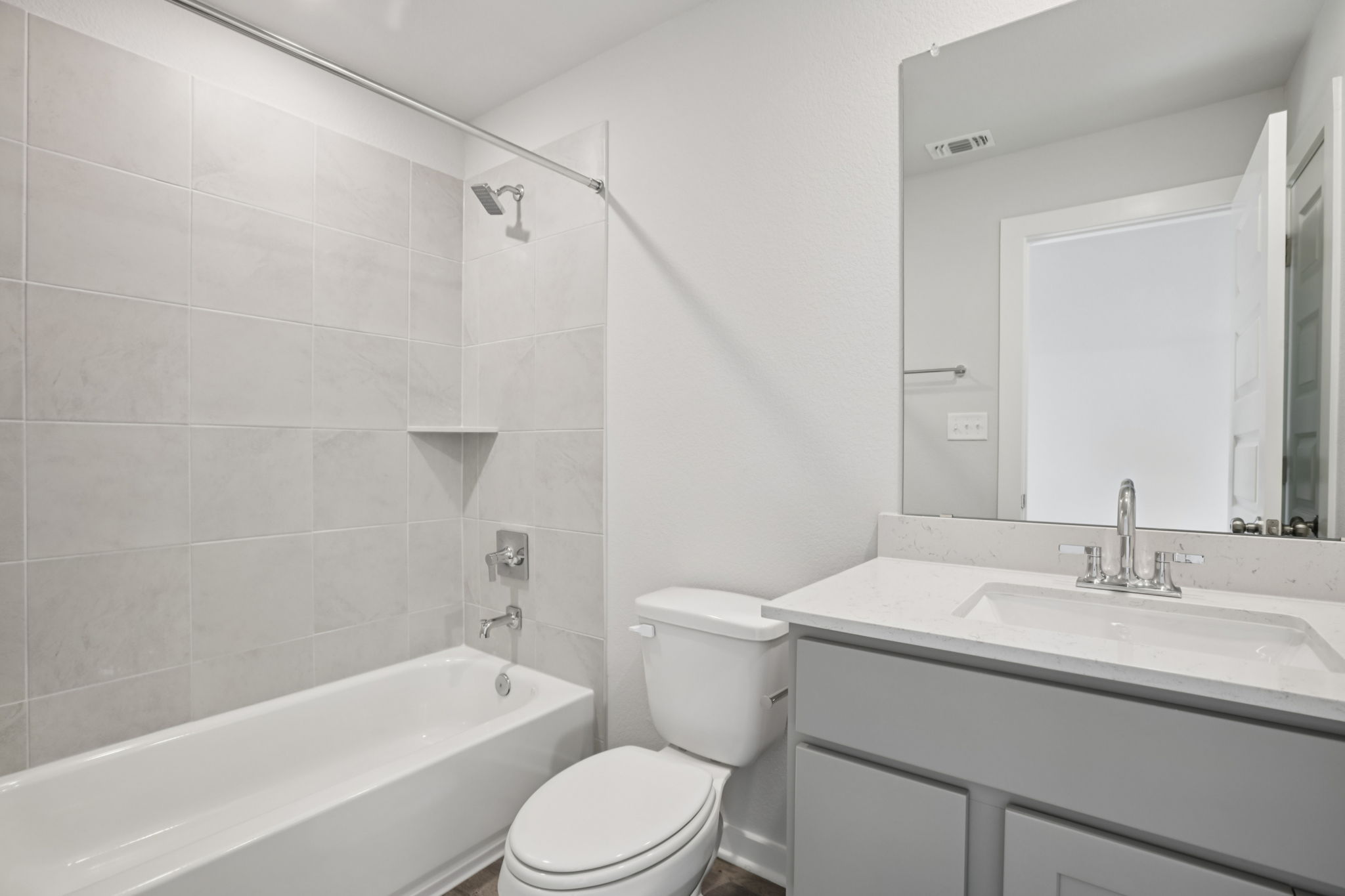 A bathroom with a tub toilet and sink.