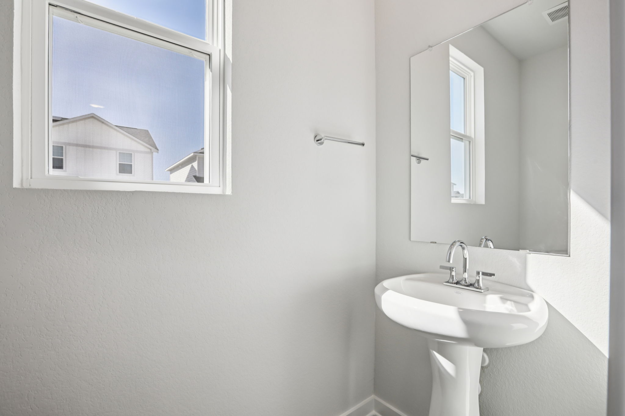 A bathroom with a sink and mirror.
