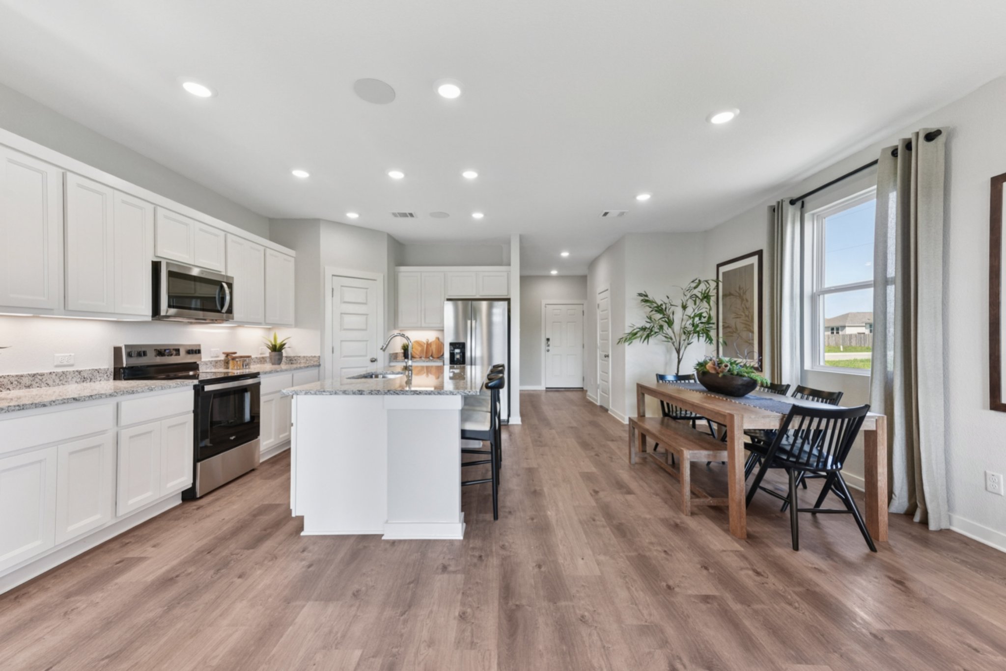 A kitchen with white cabinets.