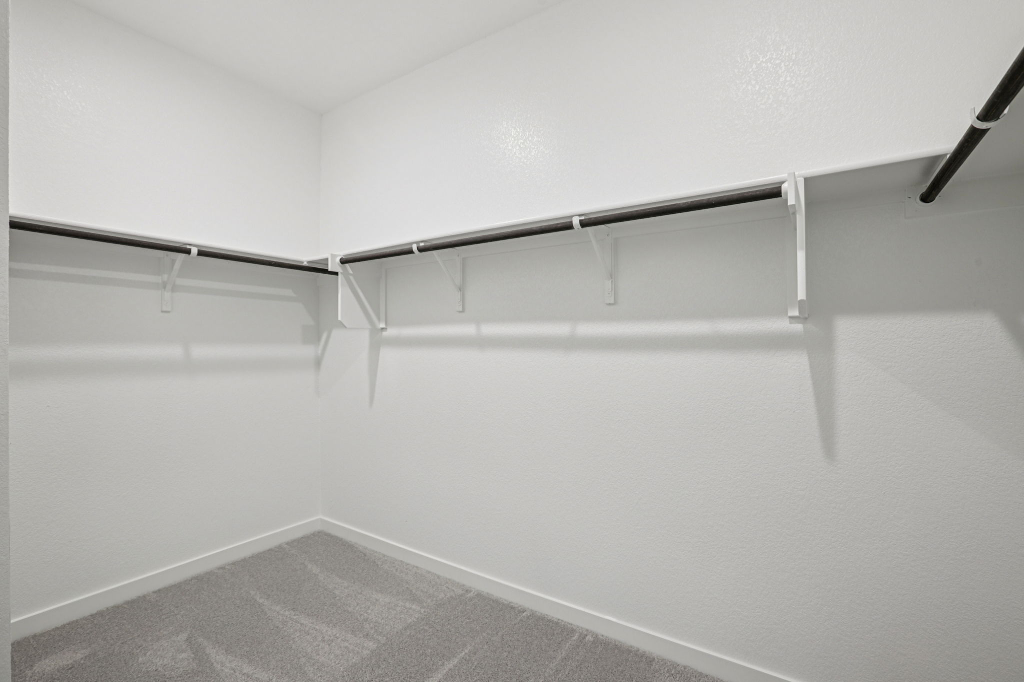 A white wall with a metal railing.