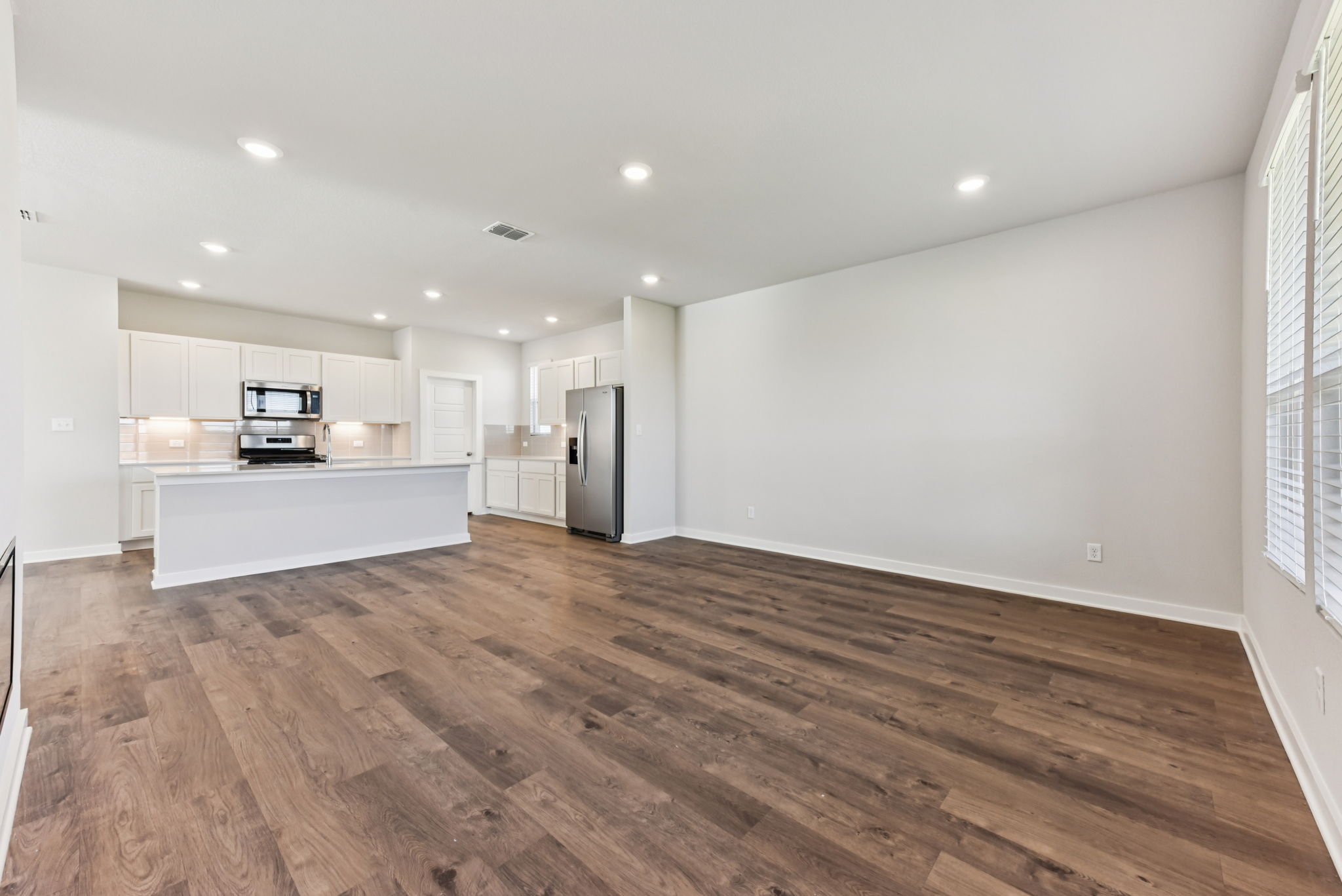 A large kitchen with white walls.