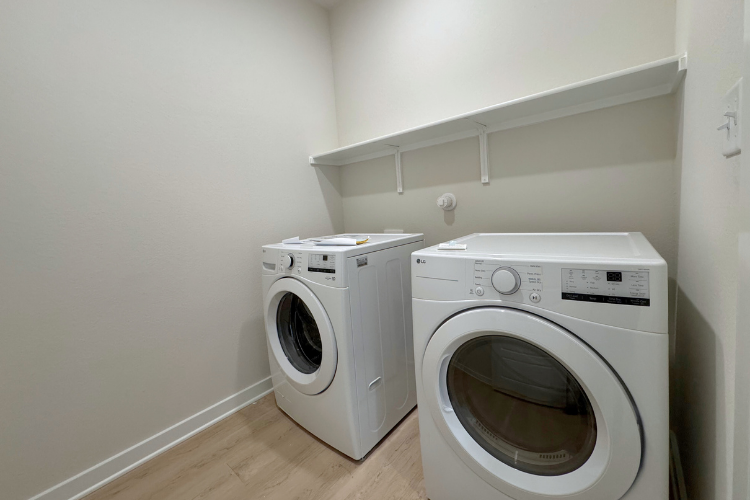 A washing machine and dryer in a room.