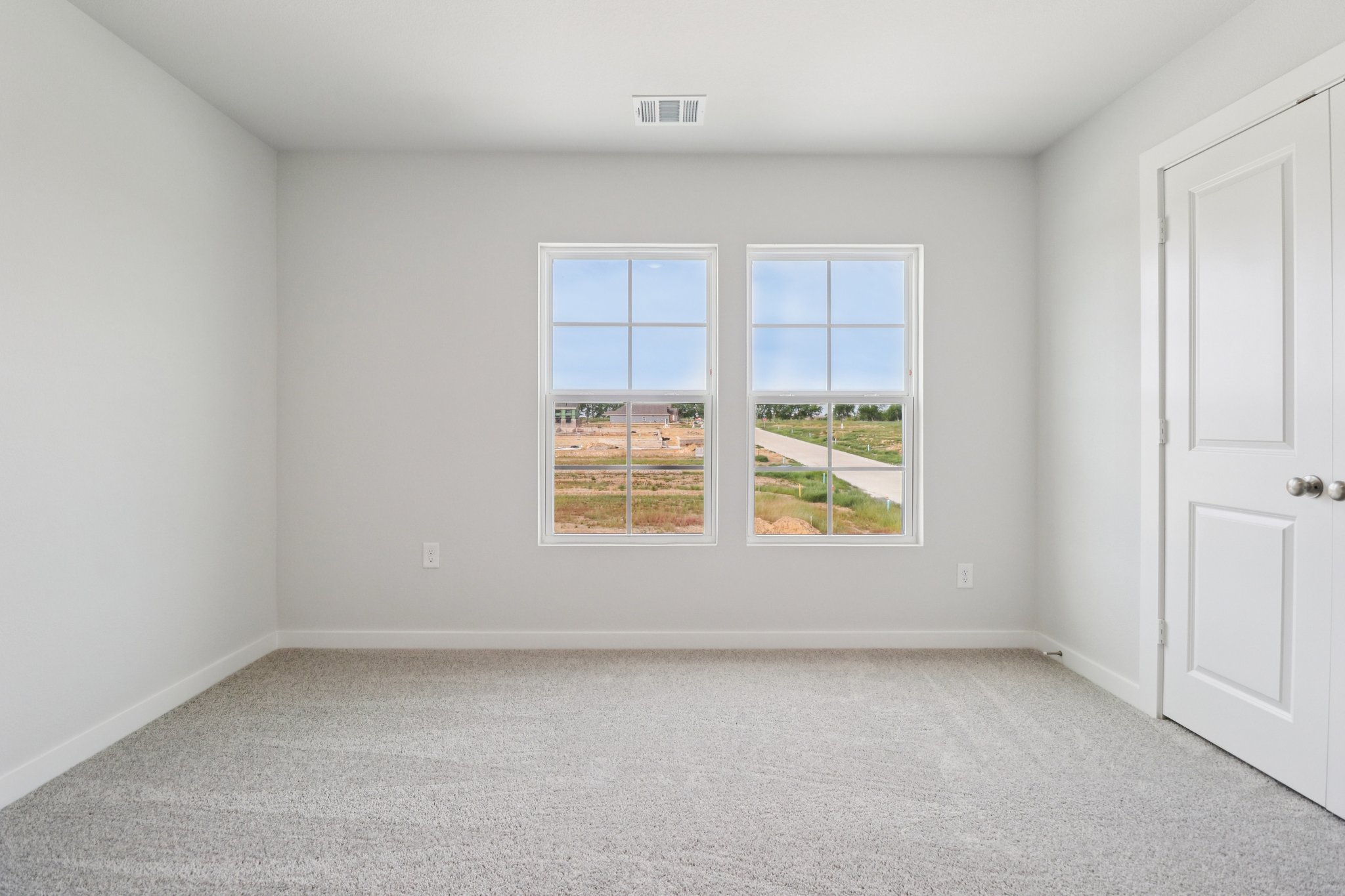 A room with a window and a door.