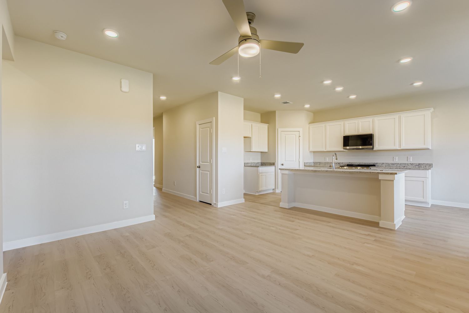 A large kitchen with white cabinets.
