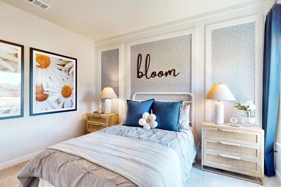 A bedroom with a bed and lamps.