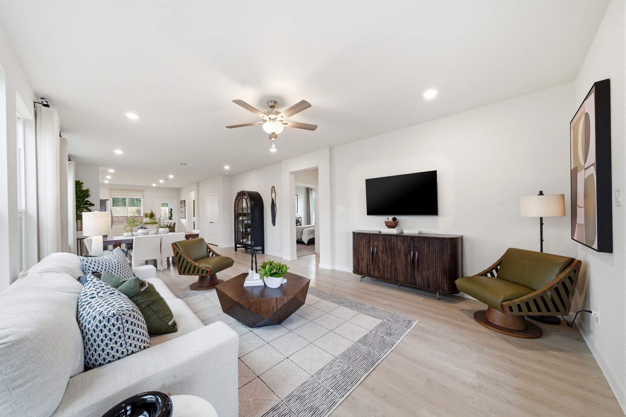 A living room with a large television.