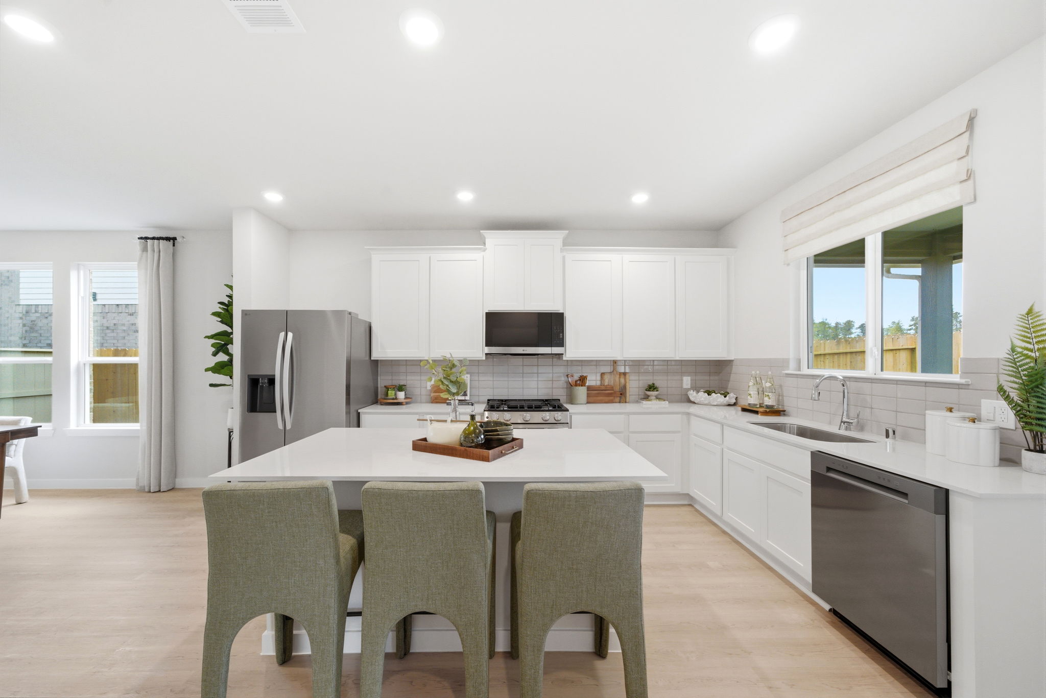 A kitchen with white cabinets.