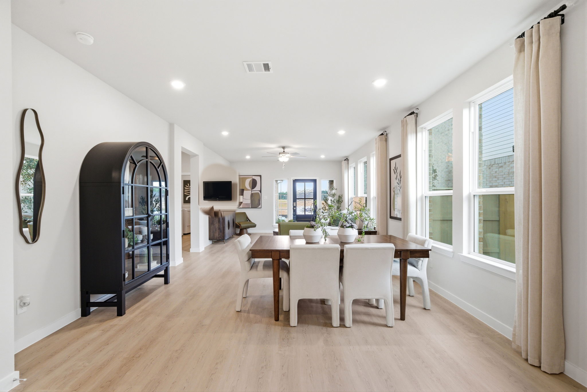 A large dining room with a wood floor.